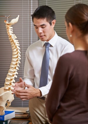 Chiropractor explaining the benefits of natural treatment